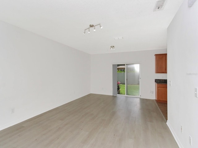 2311 Chatham Place Dr, Orlando, FL 32824 - unfurnished living room with light wood-type flooring, track lighting, and baseboards