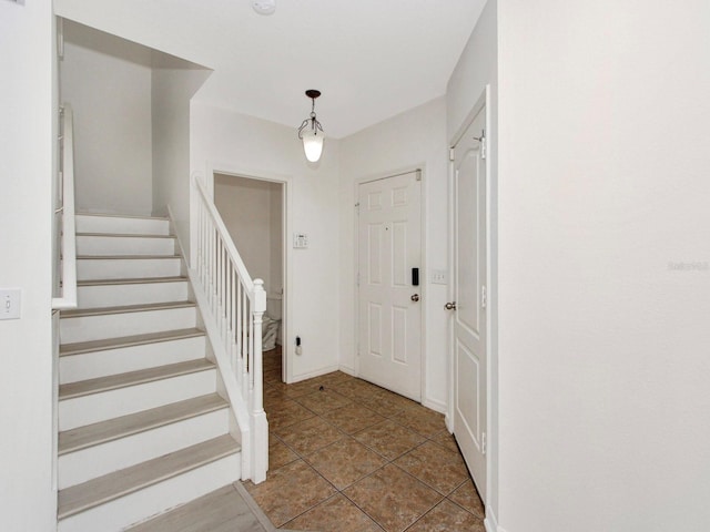 2311 Chatham Place Dr, Orlando, FL 32824 - tiled entryway with stairs and baseboards