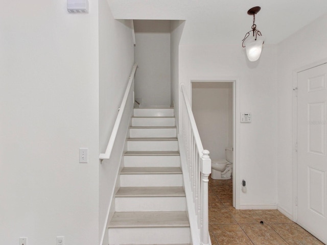 2311 Chatham Place Dr, Orlando, FL 32824 - stairway featuring tile patterned floors and baseboards