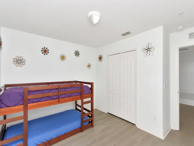 2311 Chatham Place Dr, Orlando, FL 32824 - bedroom featuring wood finished floors, a closet, and baseboards