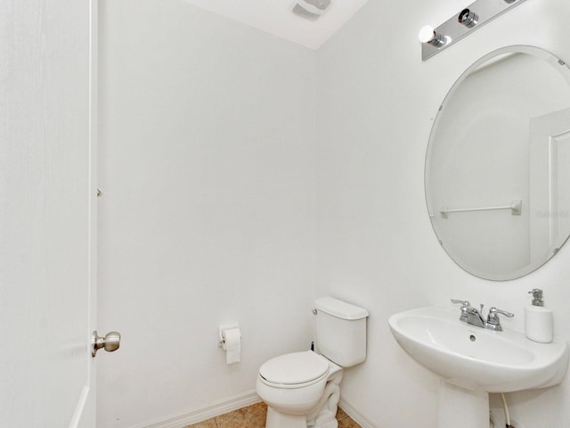 2311 Chatham Place Dr, Orlando, FL 32824 - half bathroom with toilet, a sink, baseboards, and tile patterned flooring
