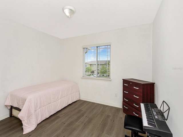 2311 Chatham Place Dr, Orlando, FL 32824 - bedroom with dark wood-style flooring and baseboards