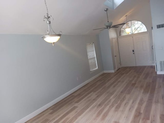 2181 Wekiwa Oaks Dr, Apopka, FL 32703 - foyer with light wood-style floors, baseboards, ceiling fan, a skylight, and vaulted ceiling