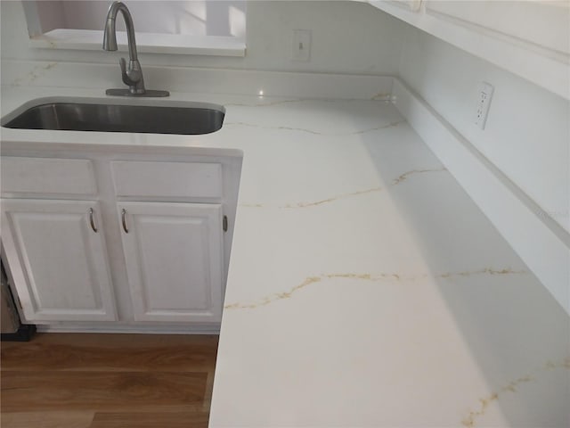 2181 Wekiwa Oaks Dr, Apopka, FL 32703 - kitchen view of a sink, white cabinetry, and wood finished floors