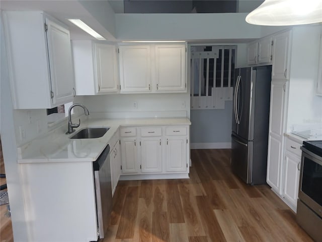 2181 Wekiwa Oaks Dr, Apopka, FL 32703 - kitchen featuring appliances with stainless steel finishes, a sink, wood finished floors, and white cabinets