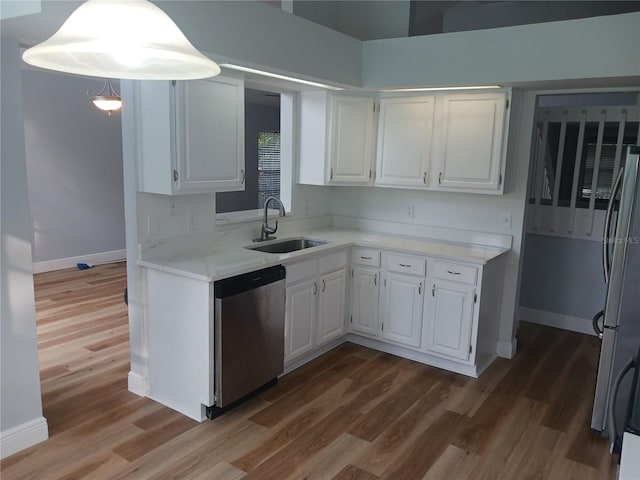 2181 Wekiwa Oaks Dr, Apopka, FL 32703 - kitchen featuring appliances with stainless steel finishes, a sink, baseboards, and white cabinets