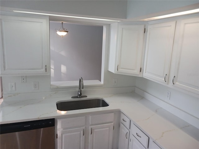 2181 Wekiwa Oaks Dr, Apopka, FL 32703 - kitchen with stainless steel dishwasher, a sink, white cabinets, and light stone counters