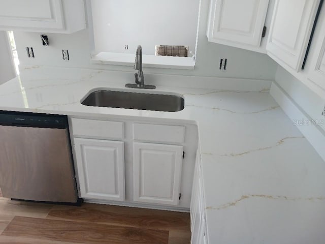 2181 Wekiwa Oaks Dr, Apopka, FL 32703 - kitchen with dishwasher, a sink, white cabinets, and light stone counters