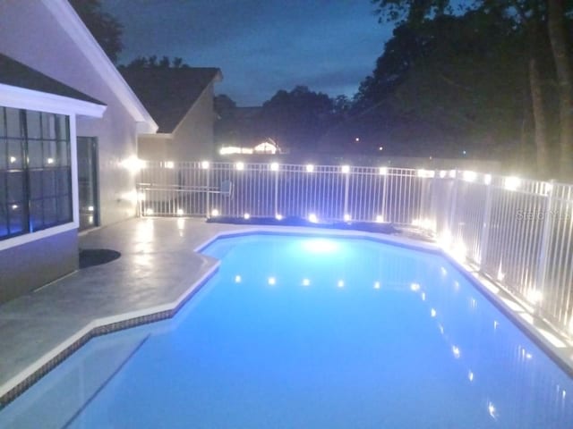 2181 Wekiwa Oaks Dr, Apopka, FL 32703 - pool at twilight featuring a patio