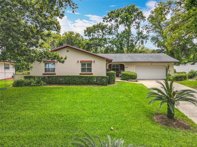 404 Broadview Ave, Altamonte Springs, FL 32701 - view of front of house with stucco siding, driveway, and a garage