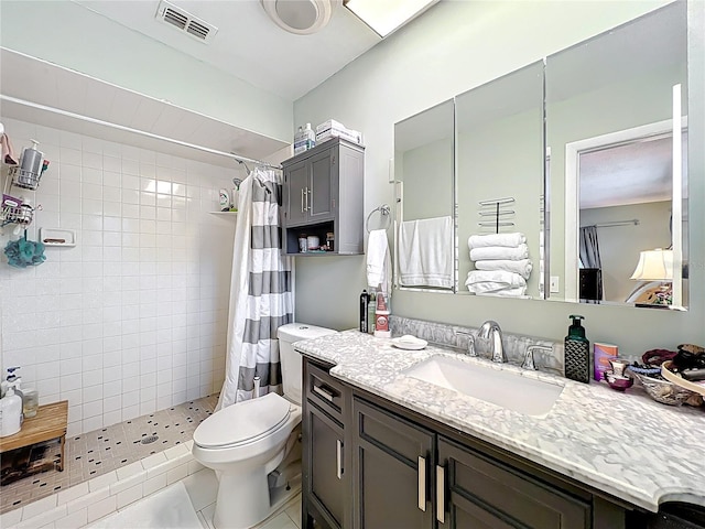 404 Broadview Ave, Altamonte Springs, FL 32701 - bathroom featuring toilet, a tile shower, vanity, and tile patterned floors