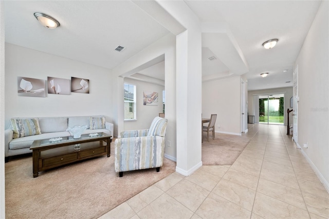 4952 Longmeadow Park St, Orlando, FL 32811 - living area with light carpet, light tile patterned floors, and baseboards