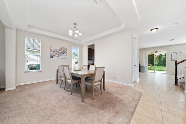 4952 Longmeadow Park St, Orlando, FL 32811 - dining space featuring a chandelier, healthy amount of natural light, a raised ceiling, and baseboards