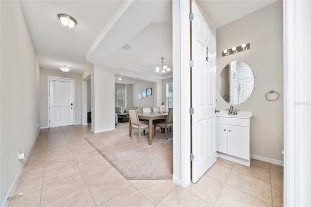 4952 Longmeadow Park St, Orlando, FL 32811 - bathroom with vanity, a chandelier, tile patterned flooring, and baseboards