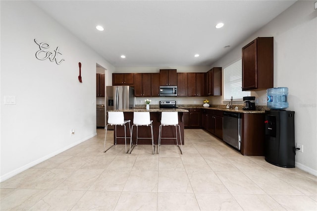 4952 Longmeadow Park St, Orlando, FL 32811 - kitchen featuring stainless steel appliances, a breakfast bar area, a sink, a center island, and recessed lighting