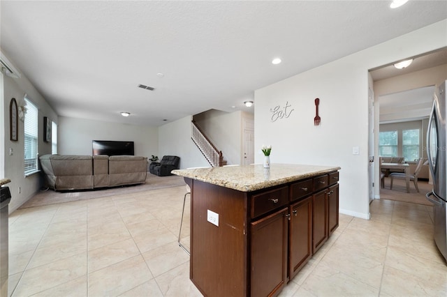 4952 Longmeadow Park St, Orlando, FL 32811 - kitchen with a breakfast bar area, recessed lighting, open floor plan, light tile patterned floors, and healthy amount of natural light