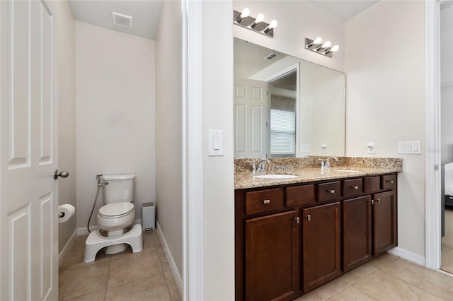 4952 Longmeadow Park St, Orlando, FL 32811 - bathroom with double vanity, tile patterned floors, toilet, and baseboards