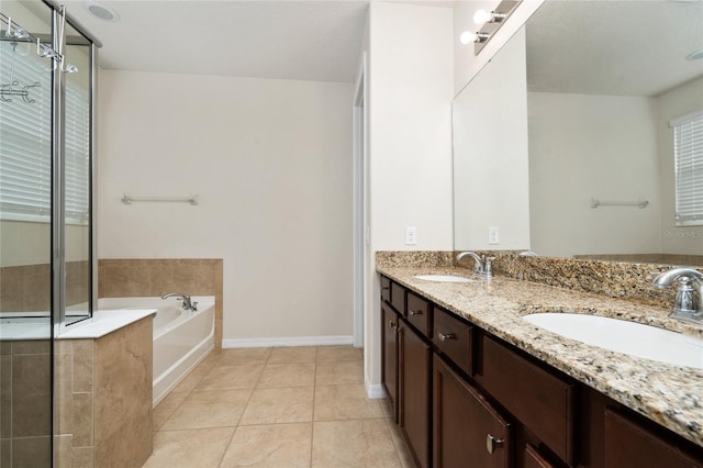 4952 Longmeadow Park St, Orlando, FL 32811 - full bath featuring a garden tub, double vanity, a stall shower, tile patterned flooring, and baseboards
