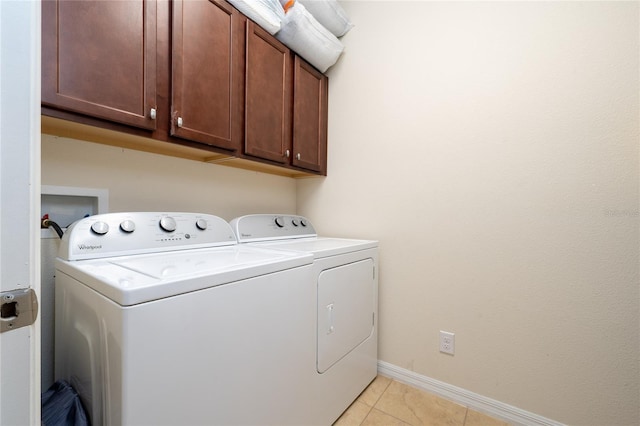 4952 Longmeadow Park St, Orlando, FL 32811 - washroom featuring cabinet space, washing machine and dryer, light tile patterned floors, and baseboards
