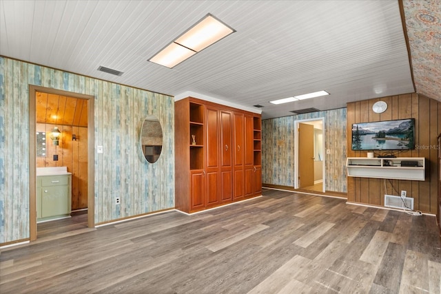 1135 Thunder Trl, Maitland, FL 32751 - unfurnished living room with wood finished floors, wallpapered walls, wooden walls, baseboards, and a sink