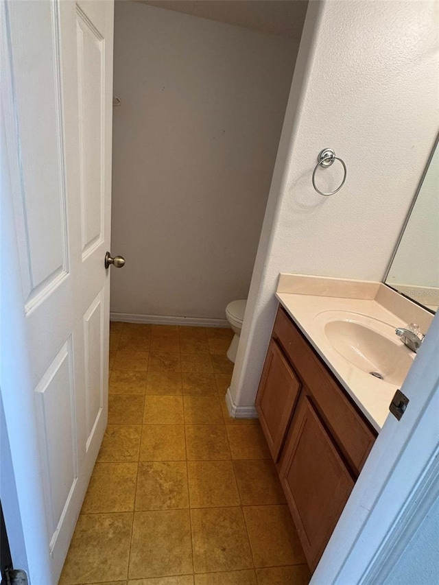2018 Cypress Bay Blvd, Kissimmee, FL 34743 - bathroom with toilet, vanity, tile patterned floors, and baseboards