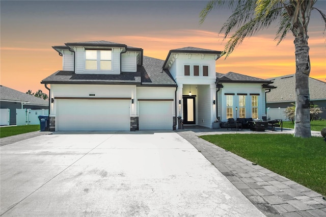 95353 Orchid Blossom Trl, Fernandina Beach, FL 32034 - view of front of house featuring driveway, a garage, a shingled roof, and stone siding