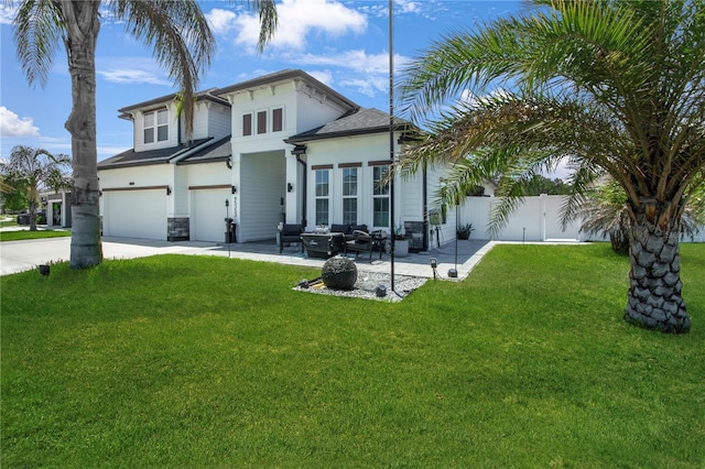 95353 Orchid Blossom Trl, Fernandina Beach, FL 32034 - view of front facade with an attached garage, concrete driveway, an outdoor living space, and a patio area