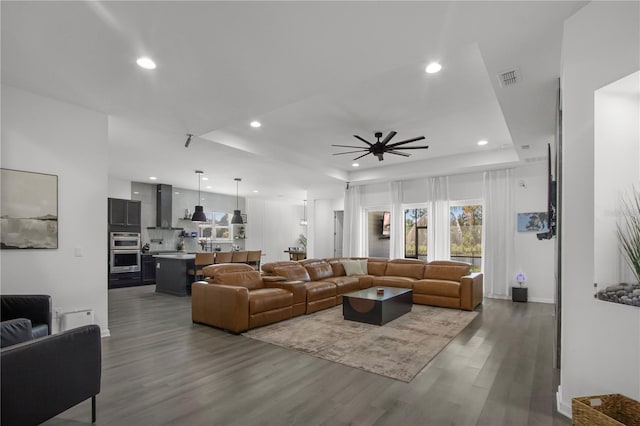95353 Orchid Blossom Trl, Fernandina Beach, FL 32034 - living room with a tray ceiling, wood finished floors, recessed lighting, and a ceiling fan