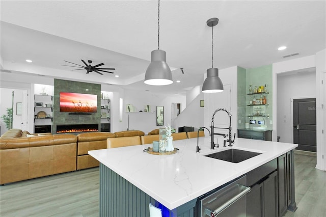 95353 Orchid Blossom Trl, Fernandina Beach, FL 32034 - kitchen with a sink, a fireplace, open floor plan, light wood-type flooring, and decorative light fixtures