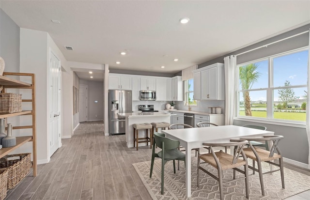 1811 Spring Shower Cir, Kissimmee, FL 34744 - dining room with baseboards, light wood-style floors, and recessed lighting