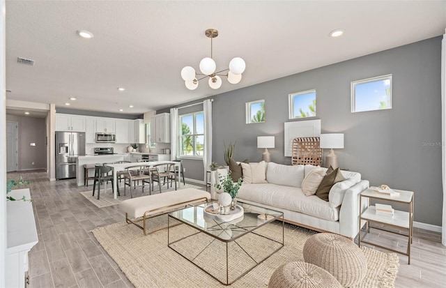 1811 Spring Shower Cir, Kissimmee, FL 34744 - living room featuring baseboards, recessed lighting, light wood-style floors, and a chandelier