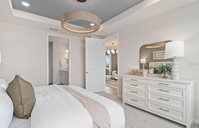 1811 Spring Shower Cir, Kissimmee, FL 34744 - bedroom featuring a raised ceiling, light colored carpet, a chandelier, connected bathroom, and recessed lighting