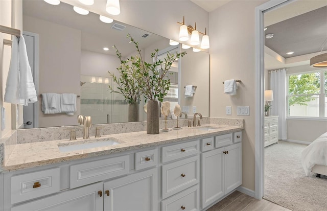 1811 Spring Shower Cir, Kissimmee, FL 34744 - ensuite bathroom with double vanity, tiled shower, baseboards, recessed lighting, and wood finished floors