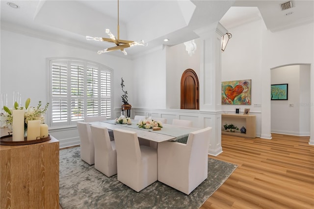 11018 Lake Butler Blvd, Windermere, FL 34786 - dining room featuring a chandelier, arched walkways, ornamental molding, light wood-style floors, and recessed lighting