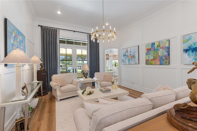 11018 Lake Butler Blvd, Windermere, FL 34786 - living area featuring crown molding, french doors, wood finished floors, a decorative wall, and arched walkways