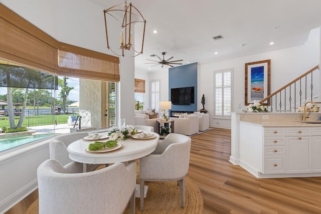 11018 Lake Butler Blvd, Windermere, FL 34786 - dining room with light wood finished floors, recessed lighting, baseboards, ceiling fan, and stairway