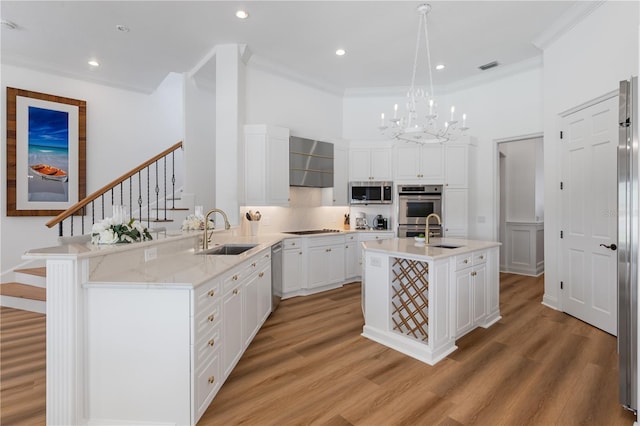 11018 Lake Butler Blvd, Windermere, FL 34786 - kitchen with a sink, appliances with stainless steel finishes, crown molding, a chandelier, and a peninsula