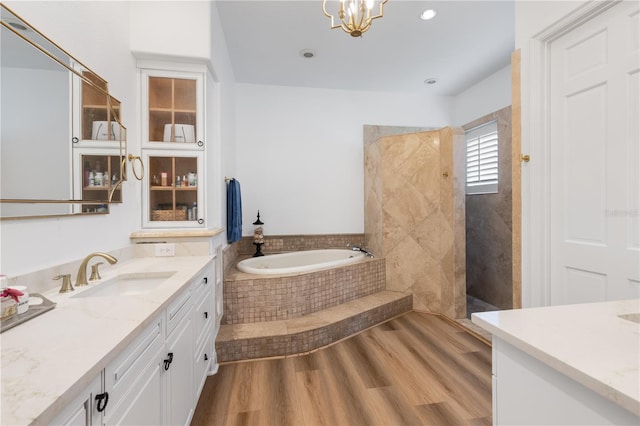 11018 Lake Butler Blvd, Windermere, FL 34786 - full bath featuring vanity, a bath, a walk in shower, wood finished floors, and a chandelier
