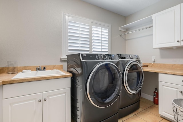 11018 Lake Butler Blvd, Windermere, FL 34786 - washroom with washer and dryer, cabinet space, and light tile patterned floors