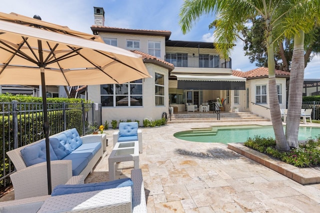 11018 Lake Butler Blvd, Windermere, FL 34786 - rear view of property featuring an outdoor hangout area, a patio area, a tile roof, stucco siding, and a balcony
