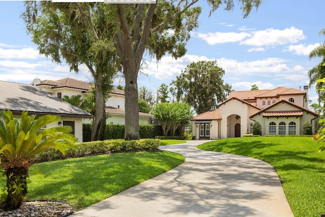11018 Lake Butler Blvd, Windermere, FL 34786 - view of front of property with stucco siding, a front yard, a tiled roof, and french doors