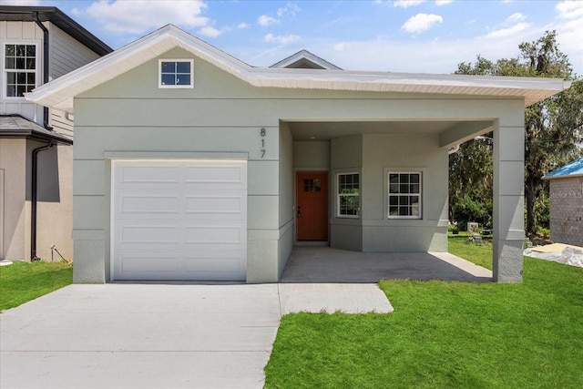 817 E Mcdonald Ave, Eustis, FL 32726 - view of front facade featuring concrete driveway, a garage, a front yard, and stucco siding