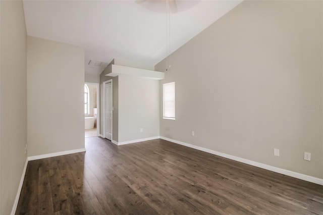 4266 Candler Ave, Spring Hill, FL 34609 - unfurnished room featuring vaulted ceiling, healthy amount of natural light, dark wood-type flooring, ceiling fan, and baseboards