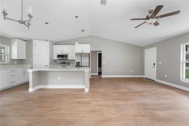 9299 N Tahiti Way, Citrus Springs, FL 34433 - kitchen featuring stainless steel appliances, vaulted ceiling, ceiling fan, light countertops, and white cabinets