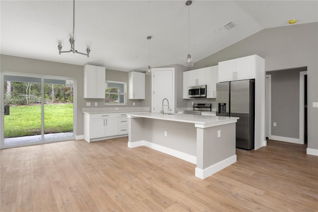 9299 N Tahiti Way, Citrus Springs, FL 34433 - kitchen with stainless steel appliances, light countertops, an island with sink, white cabinetry, and vaulted ceiling