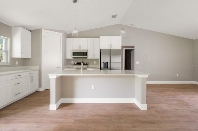 9299 N Tahiti Way, Citrus Springs, FL 34433 - kitchen with stainless steel appliances, lofted ceiling, an island with sink, white cabinetry, and a sink