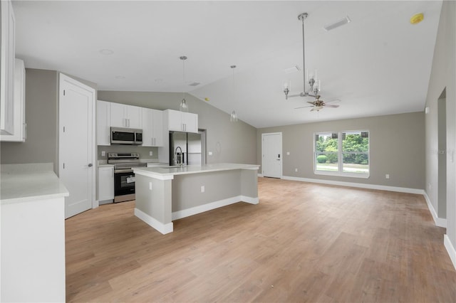 9299 N Tahiti Way, Citrus Springs, FL 34433 - kitchen featuring appliances with stainless steel finishes, lofted ceiling, light countertops, white cabinetry, and a center island with sink