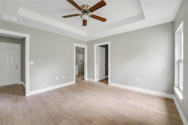9299 N Tahiti Way, Citrus Springs, FL 34433 - empty room featuring a raised ceiling, baseboards, a ceiling fan, and light wood finished floors