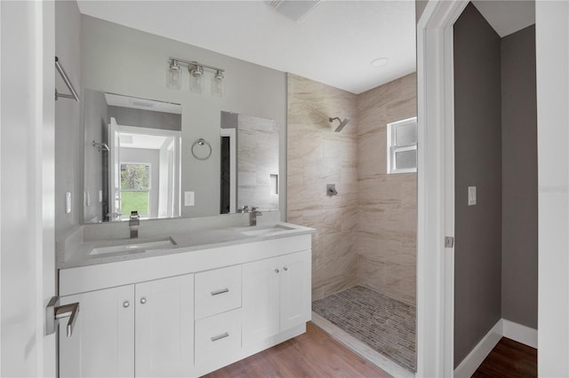9299 N Tahiti Way, Citrus Springs, FL 34433 - bathroom with a tile shower, double vanity, and wood finished floors