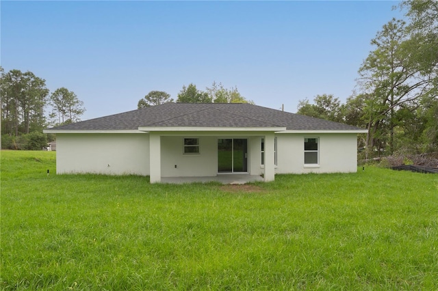 9299 N Tahiti Way, Citrus Springs, FL 34433 - rear view of house with a lawn, a patio, stucco siding, and roof with shingles
